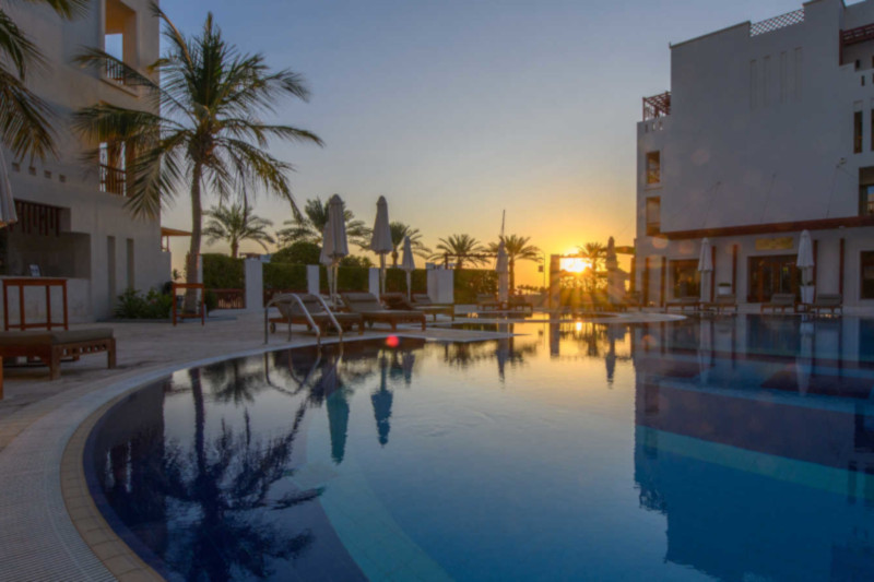 swimming pool at sifawy hotel at sunset with hotel view