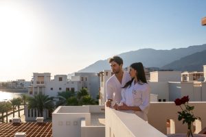 A couple watching the view from their room at Sifawy Boutique hotel Jebel Sifah